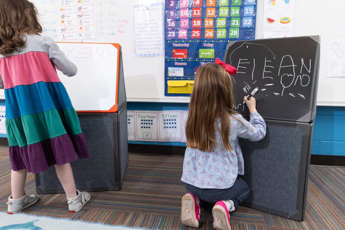 Kindergarten teacher guiding a student through phoneme segmentation using three counters in sound boxes.