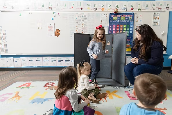 Child stepping along taped floor marks during a phoneme segmentation activity.