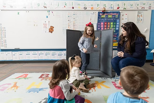 Child stepping along taped floor marks during a phoneme segmentation activity.