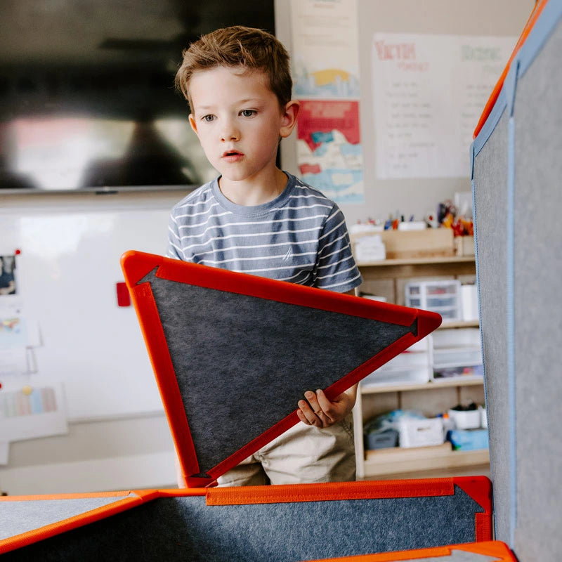 Boy in the classroom holding a Superspace triangle panel